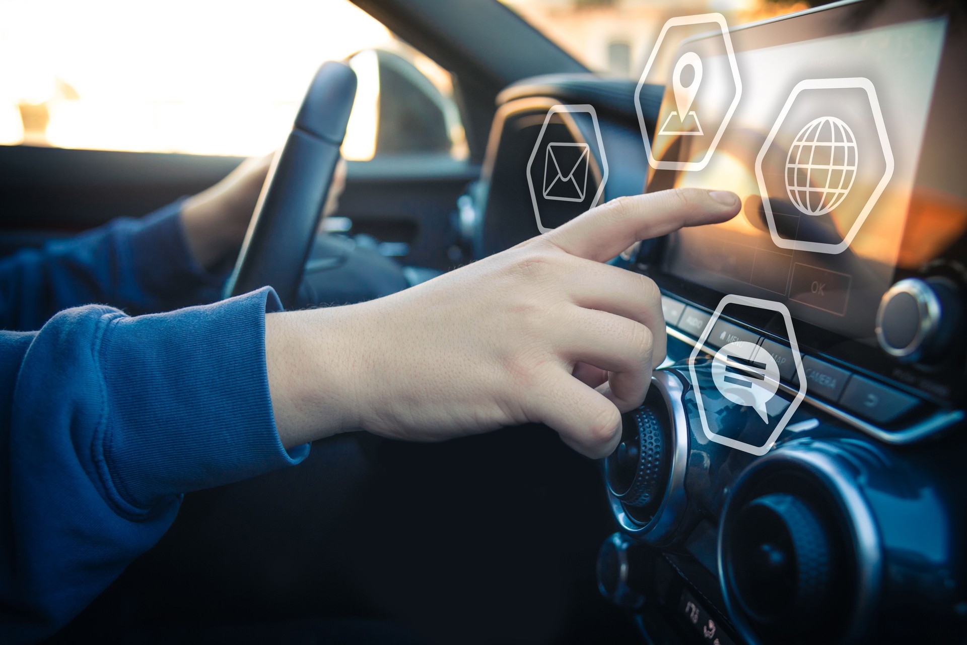Drive a car and use smartphone. Reading messages holding a cell phone while driving. Transportation and new automotive technology concept. Infotainment, navigation, multimedia communication device